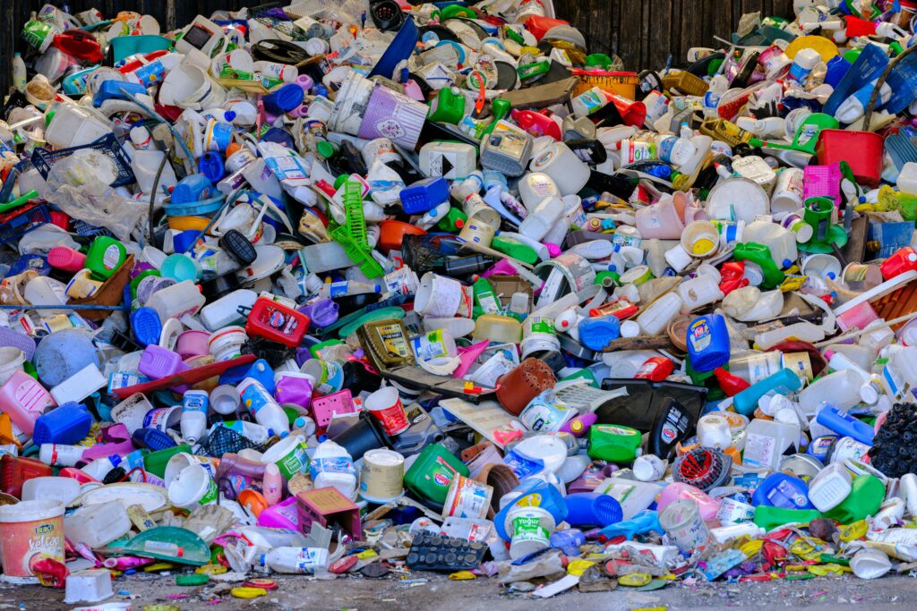 Massive colorful collection of used plastic bottles and containers in a recycling center.